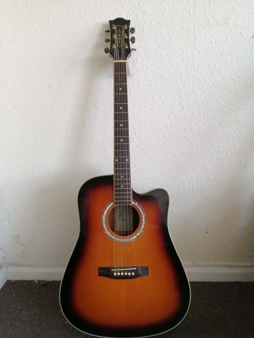 An EKO electro acoustic guitar, with hard case